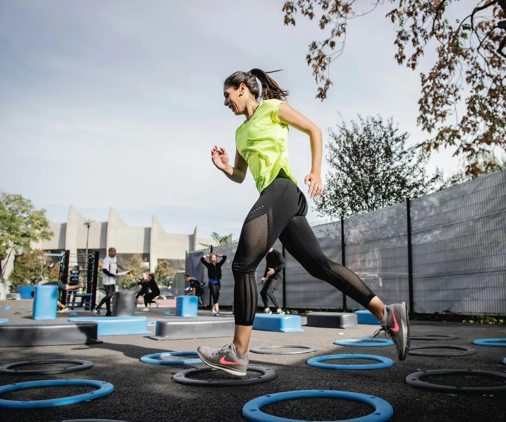 Woman running through an outdoor training course